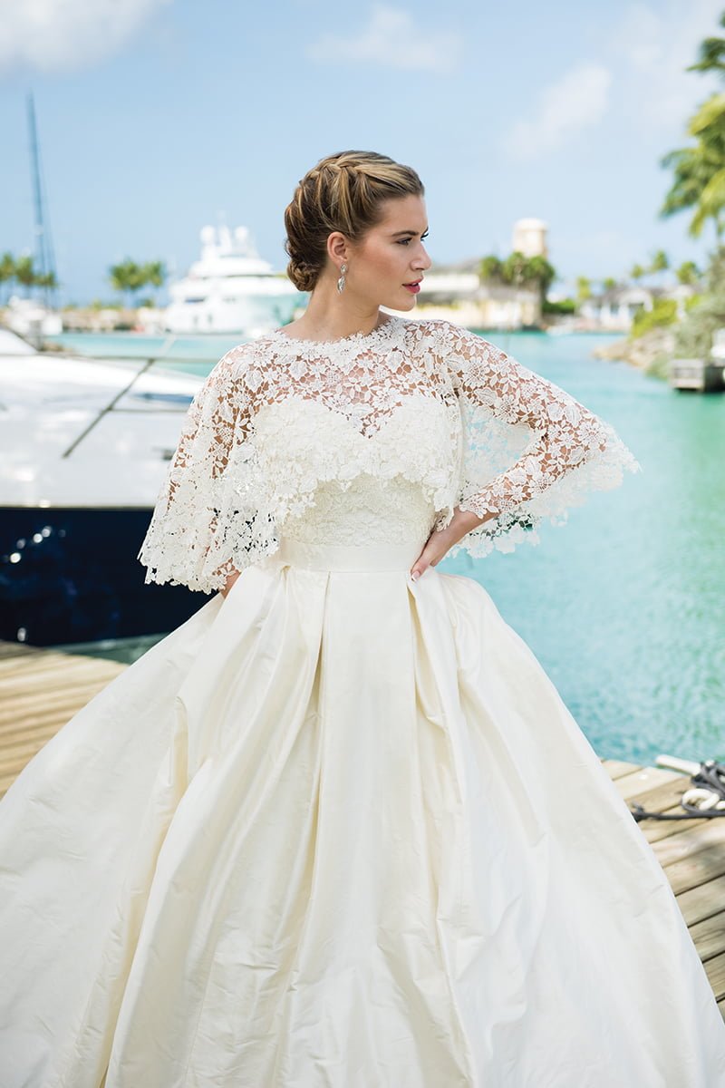 destination wedding dresses Wild Romance gown in silk satin, silk taffeta and guipure lace, from £1,795; matching cape, from £445; Ivory & Co Bridal